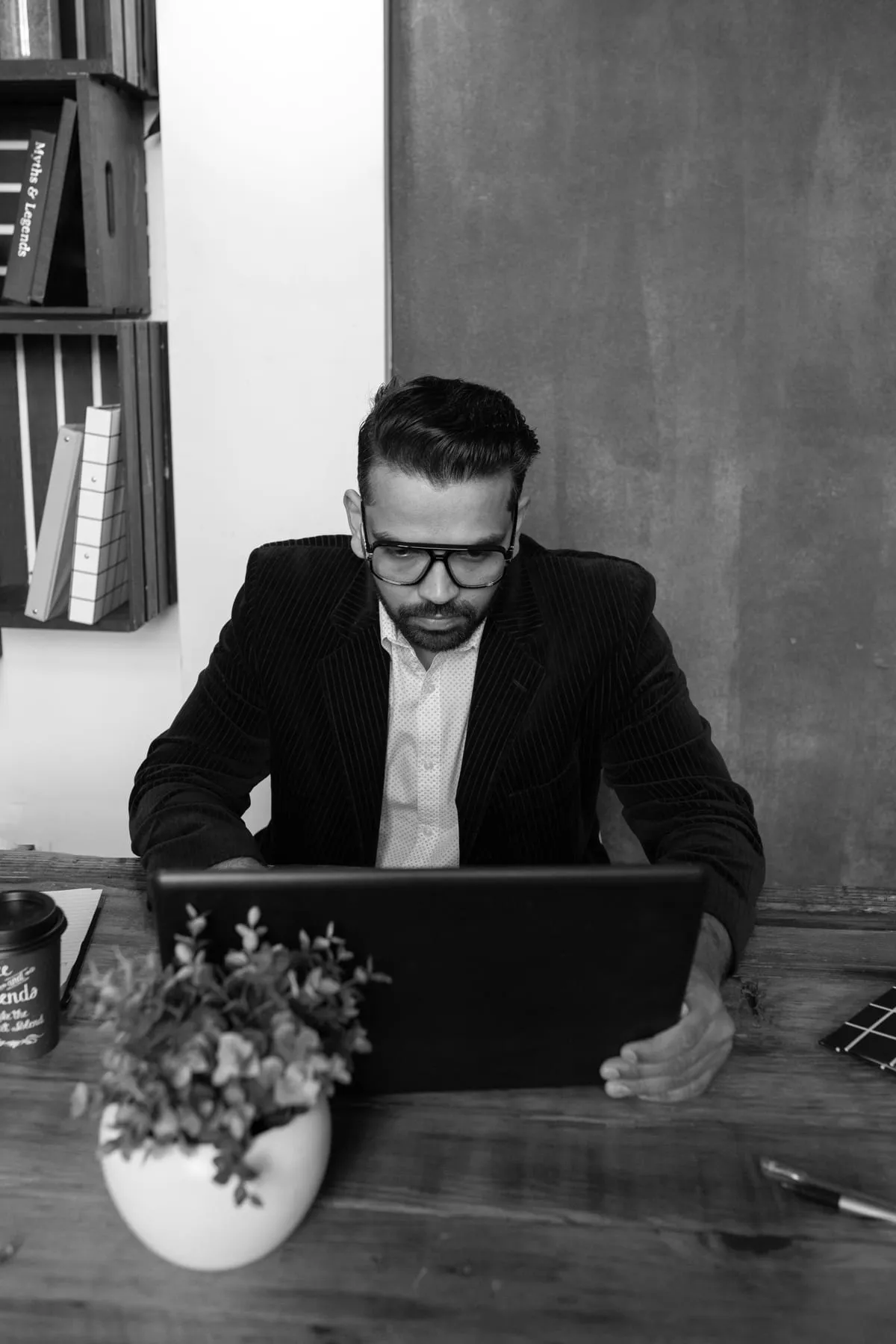 A business owner working on a laptop at his desk