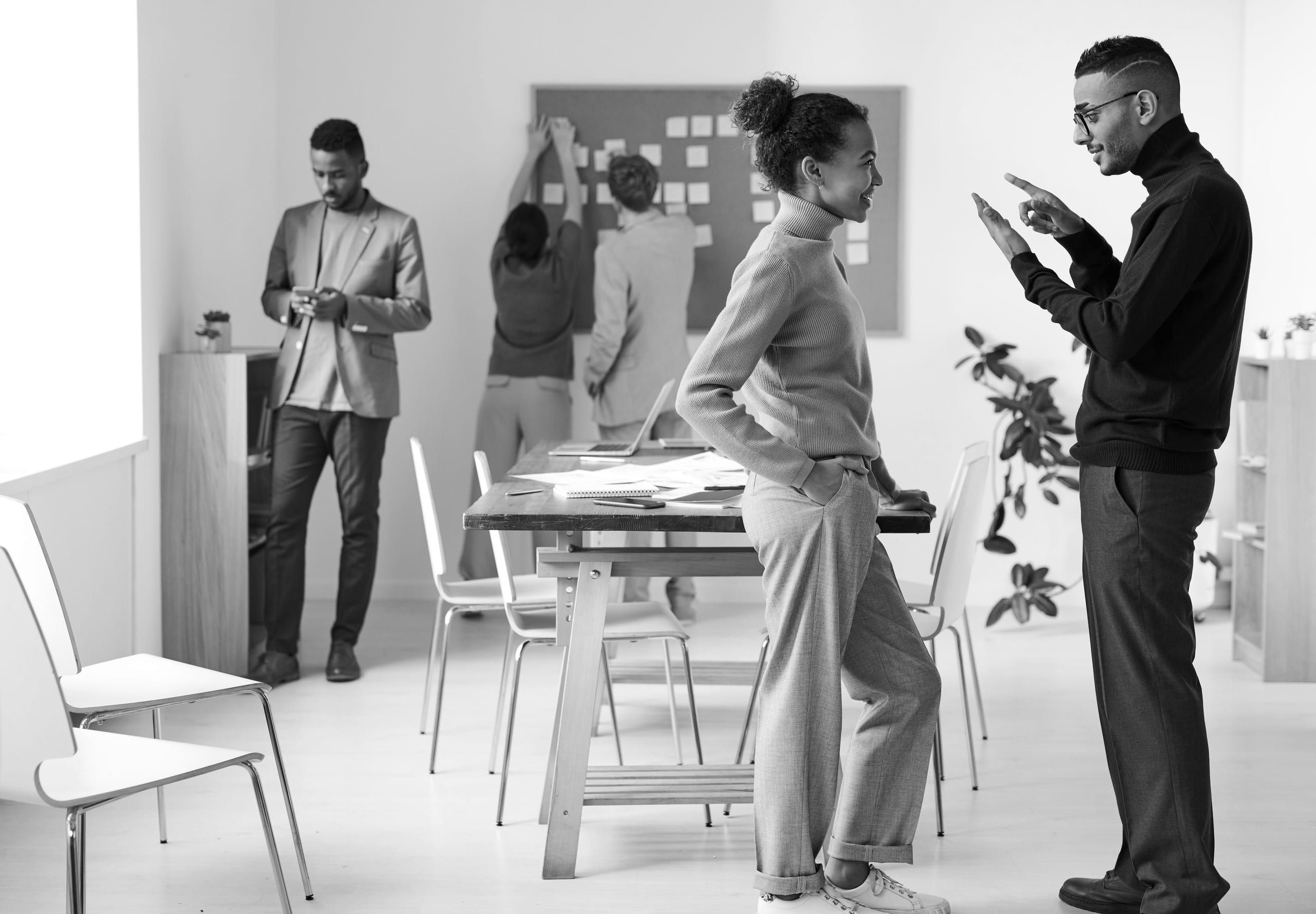 A small team talking in an open office