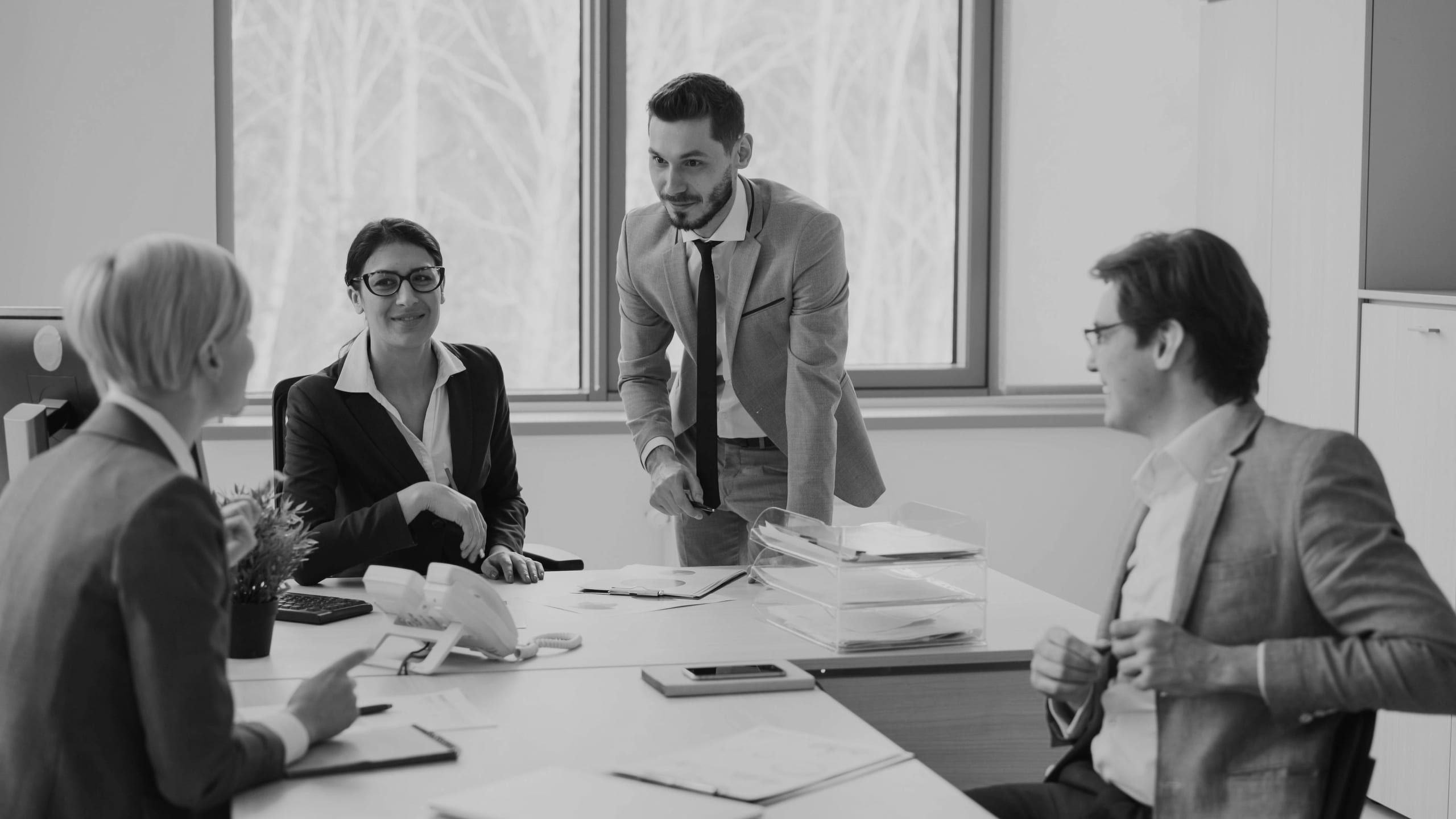 A sales team in a meeting with a client at a conference table
